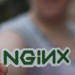 Person Holding a Sticker with Green Letters